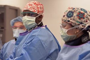 Three care team members in scrubs.