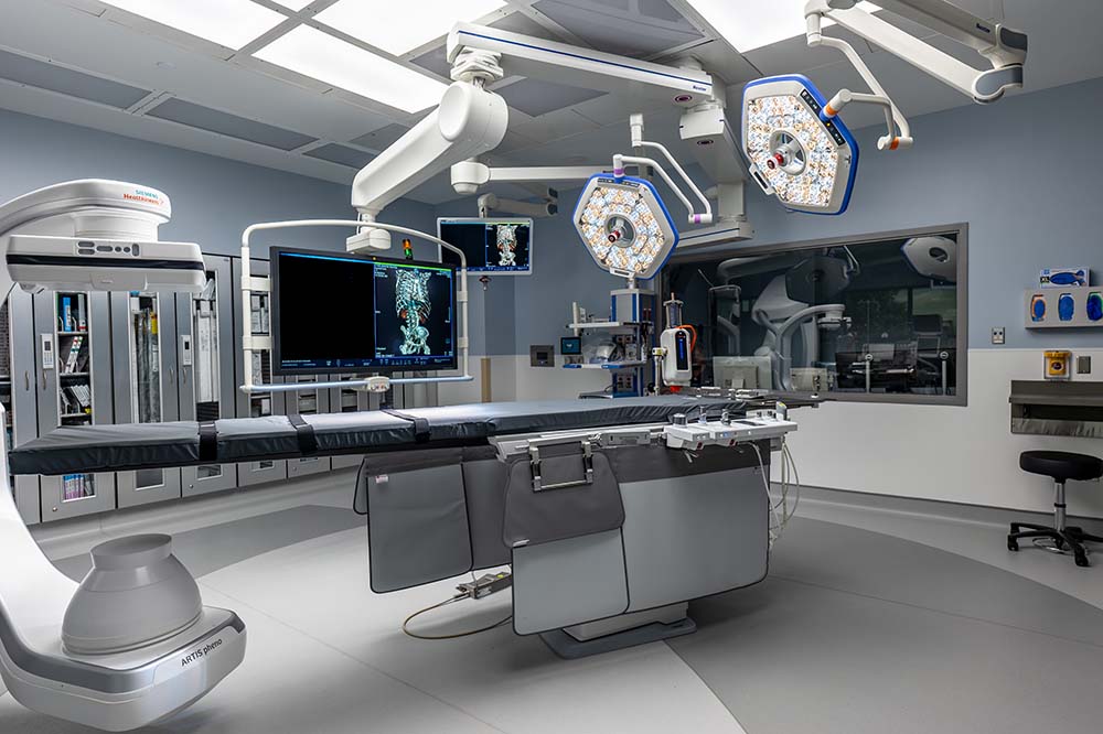 A new operating room with monitors, lights and an operating table.