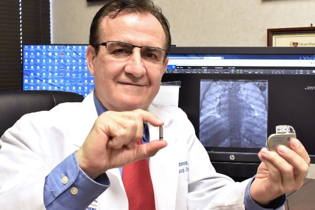 Dr. Rahman holding pacemaker