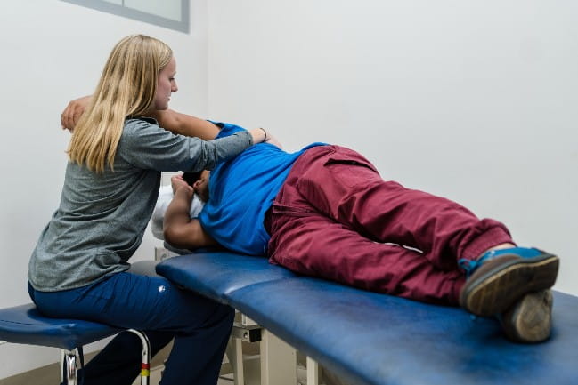 Care team member working with rehabilitation patient.